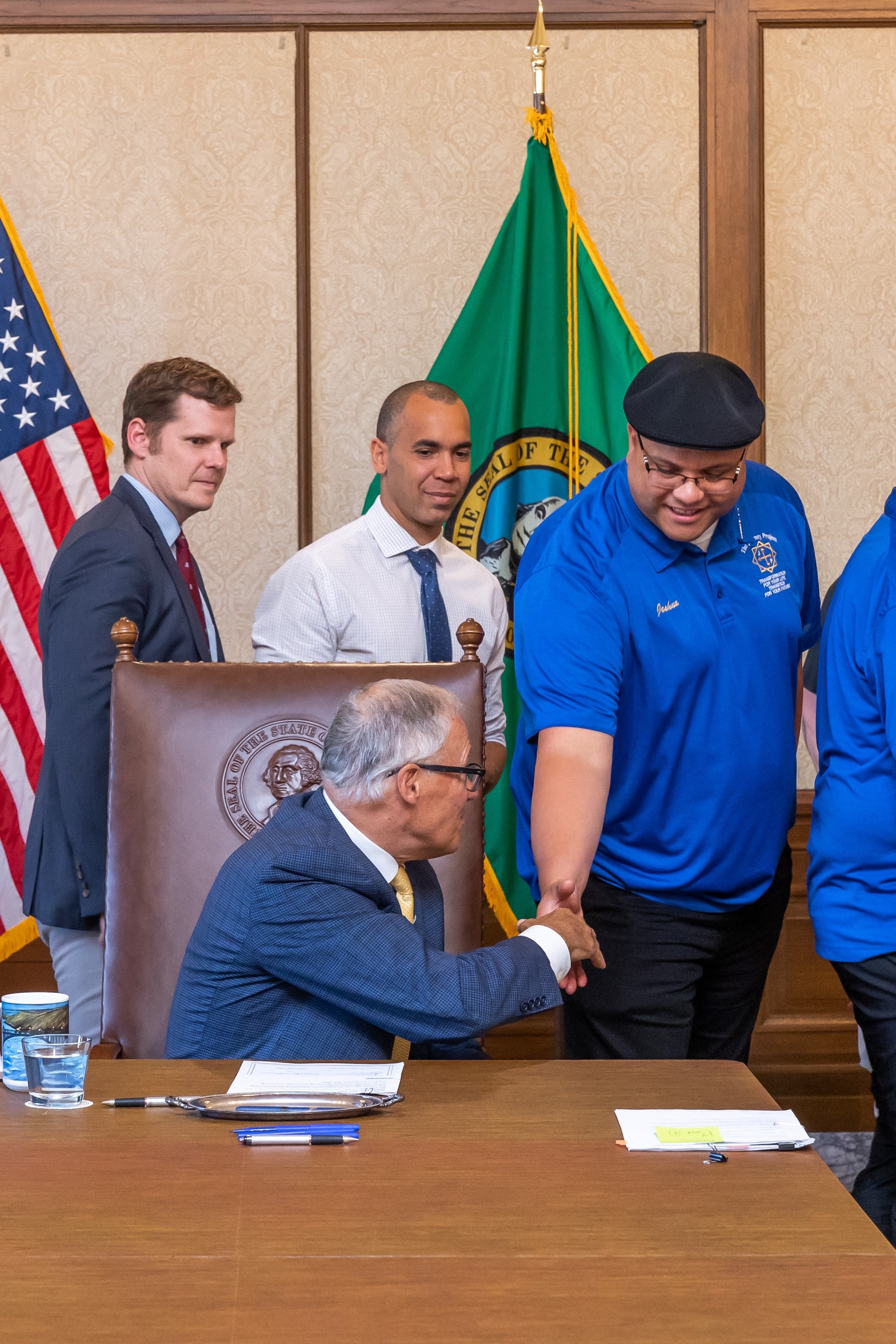 One of our Directors Joshua shaking the hand of Governor Inslee.